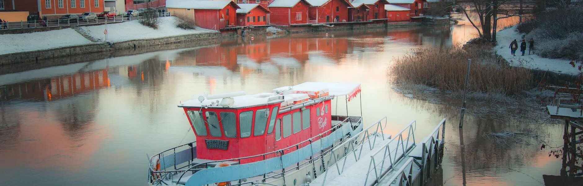 white boat on water near houses